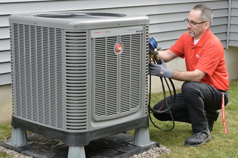 An employee doing a check on the outside generator using diagnostic tools