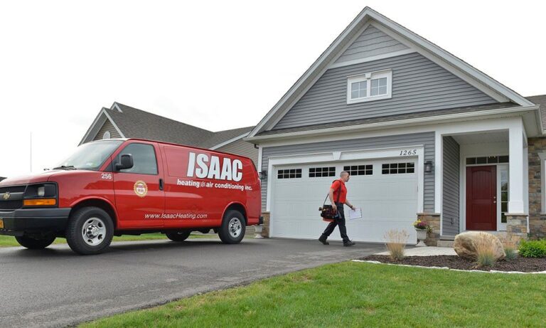 An employee going into a modern one story home to quote his potential customers.