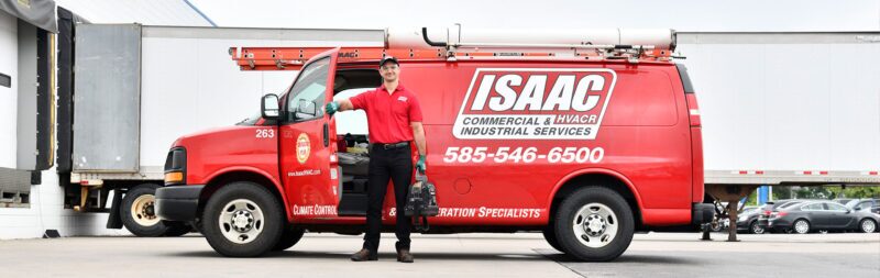 An employee holding the door to the Isaac truck smiling for the picture.
